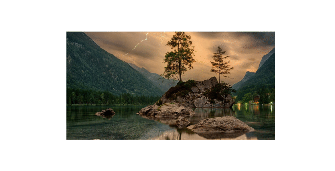 Scenic daytime lake view with green trees and brown rock formation, ideal for nature blogs.